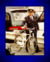 Policeman walking bike in Tokyo