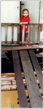 Young Girl at the Front Door to 
Her Boat House